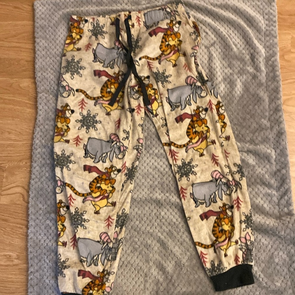 Pajama pants with Winnie the Pooh characters on it